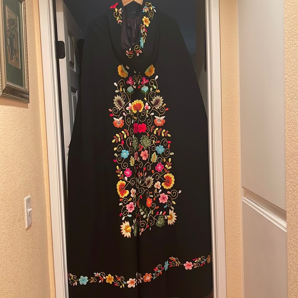 Wool cape made in Ecuador.  Length is 54 inches , fully lined  with slit pockets